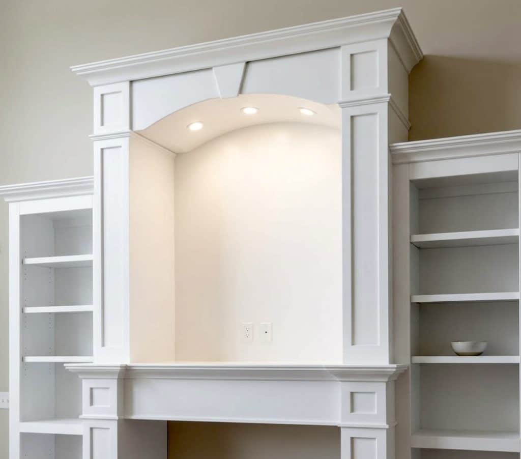 White built-in shelving and fireplace mantel with smooth painted finish and clean modern design